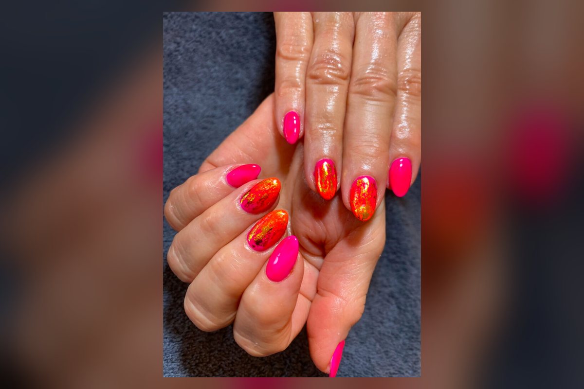Bright pink and orange gel nails with gold foil detail